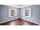 A well-lit bedroom with hardwood floors and two windows providing ample natural light at 881 Mclinden Se Ave, Smyrna, GA 30080