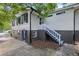 Side view of home with a staircase, two stories, and partial basement at 881 Mclinden Se Ave, Smyrna, GA 30080