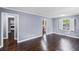 Inviting living room boasts gleaming hardwood floors and shuttered windows at 881 Mclinden Se Ave, Smyrna, GA 30080