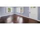 Inviting living room boasts gleaming hardwood floors and shuttered windows offering great light at 881 Mclinden Se Ave, Smyrna, GA 30080