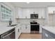A beautifully updated kitchen features quartz counters, white subway tile backsplash, and stainless steel appliances at 3176 Pollard St, Atlanta, GA 30344