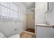 Bathroom featuring neutral walls, pedestal sink, and walk-in shower at 3595 Limberlost Sw Trl, Stockbridge, GA 30281