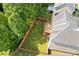 Aerial view of fenced backyard with a deck, grassy lawn, and mature trees, ideal for privacy at 4474 Michael Jay St, Snellville, GA 30039