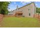 Fenced backyard with lush green lawn and a multi-level deck, ideal for outdoor gatherings at 4474 Michael Jay St, Snellville, GA 30039