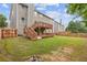 Expansive backyard featuring a well-maintained lawn and a wooden deck with stairs at 4474 Michael Jay St, Snellville, GA 30039