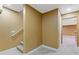 View of basement featuring carpeted stairs, tan walls, and view of finished basement beyond at 4474 Michael Jay St, Snellville, GA 30039
