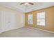 Bedroom featuring neutral walls, carpet, tray ceiling, closet, and two bright windows at 4474 Michael Jay St, Snellville, GA 30039