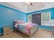 Bright bedroom with blue walls, tray ceiling, carpet flooring, and two windows at 4474 Michael Jay St, Snellville, GA 30039
