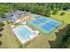 Aerial view highlighting a community with a refreshing pool, tennis courts, playground, and well-maintained grounds at 4474 Michael Jay St, Snellville, GA 30039