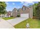 View of home's exterior with long driveway, manicured lawn, and neatly trimmed shrubbery at 4474 Michael Jay St, Snellville, GA 30039