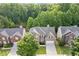 Aerial shot showcasing a two-story brick home with manicured lawn, mature trees, and a two car garage at 4474 Michael Jay St, Snellville, GA 30039
