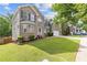 Two story brick home featuring a green lawn, brick facade, and large front-facing windows at 4474 Michael Jay St, Snellville, GA 30039