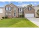 Beautiful two-story brick home with a well-manicured lawn and attached two car garage at 4474 Michael Jay St, Snellville, GA 30039