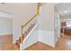 Open foyer with staircase, hardwood floors, and views into other living spaces at 4474 Michael Jay St, Snellville, GA 30039