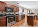 Well-equipped kitchen with stainless steel appliances, cherry cabinets, and hardwood floors at 4474 Michael Jay St, Snellville, GA 30039