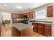 Open kitchen features an island, stainless steel appliances, and hardwood floors at 4474 Michael Jay St, Snellville, GA 30039