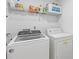 Bright laundry room with shelving above washer and dryer units at 4474 Michael Jay St, Snellville, GA 30039