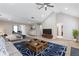 Spacious living room featuring a vaulted ceiling, plush carpet, and large windows at 4474 Michael Jay St, Snellville, GA 30039