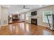 Open concept living room and kitchen features hardwood floors and a fireplace at 4474 Michael Jay St, Snellville, GA 30039