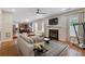 Inviting living room with fireplace, ceiling fan, and seamless flow into the open kitchen at 4474 Michael Jay St, Snellville, GA 30039