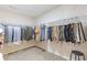 Walk-in closet with ample hanging storage and carpeted flooring at 4474 Michael Jay St, Snellville, GA 30039
