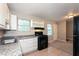Close up shot of kitchen features white cabinets, black gas range, and granite countertop at 1079 Stonewall Drive Southeast, Atlanta, GA 30315