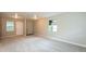 Bright living room featuring neutral paint, carpeted floor, and natural light from the windows at 1079 Stonewall Drive Southeast, Atlanta, GA 30315