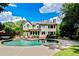Gorgeous backyard oasis featuring a sparkling pool, patio area, and meticulously landscaped grounds at 121 Fairway Overlook, Woodstock, GA 30188