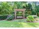 Relaxing backyard retreat featuring a charming swing on a pergola, surrounded by lush greenery at 121 Fairway Overlook, Woodstock, GA 30188