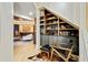 Living area with custom bar and shelving under the staircase at 121 Fairway Overlook, Woodstock, GA 30188