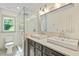 Modern bathroom featuring a glass-enclosed shower, a toilet, and a vanity with double sinks and stylish fixtures at 121 Fairway Overlook, Woodstock, GA 30188