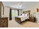 Cozy bedroom featuring a rustic wood bed frame, decorative lamps, and a dresser with a mirror reflecting natural light at 121 Fairway Overlook, Woodstock, GA 30188