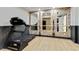 Well-equipped exercise room featuring a treadmill and brick accent wall with mirrors and ballet bar at 121 Fairway Overlook, Woodstock, GA 30188