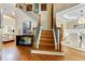 Staircase in foyer with hardwood floors leading to dining room and living room at 121 Fairway Overlook, Woodstock, GA 30188