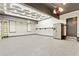 Spacious three-car garage featuring epoxy flooring, modern lighting, and ample storage space at 121 Fairway Overlook, Woodstock, GA 30188