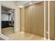 Hallway with decorative wood slat wall with integrated lighting leading to the exercise room at 121 Fairway Overlook, Woodstock, GA 30188
