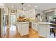 Gourmet kitchen with stainless steel appliances, marble countertops, white cabinetry and a large island at 121 Fairway Overlook, Woodstock, GA 30188