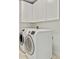 Functional laundry room with a front load washer, a front load dryer and plenty of storage cabinets at 121 Fairway Overlook, Woodstock, GA 30188