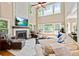 Spacious living room boasts high ceilings, fireplace, and multiple windows providing ample natural light and scenic views at 121 Fairway Overlook, Woodstock, GA 30188