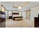 Spacious main bedroom with tray ceiling, barn doors, soft carpet, and neutral tones creating a peaceful retreat at 121 Fairway Overlook, Woodstock, GA 30188