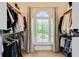 Well-organized walk-in closet providing shelving and hanging space for clothing and accessories and a window with light at 121 Fairway Overlook, Woodstock, GA 30188