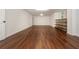 Finished basement with hardwood flooring, white walls and a door and a window at 210 Hunters Vw, Roswell, GA 30075