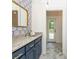 Stylish bathroom with modern vanity, elegant mirror, and marble floors leading to an outside deck at 210 Hunters Vw, Roswell, GA 30075