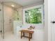 Bathroom with a soaking tub with a view of the yard and a separate glass shower at 210 Hunters Vw, Roswell, GA 30075