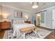 Cozy bedroom with neutral paint, wood floors, a patterned rug, and an ensuite bathroom at 210 Hunters Vw, Roswell, GA 30075