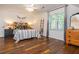 Inviting bedroom with hardwood floors, a large bed, and bright natural light at 210 Hunters Vw, Roswell, GA 30075