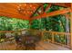 Spacious covered deck with wood ceiling, a chandelier, and overlooking a lush, green backyard at 210 Hunters Vw, Roswell, GA 30075