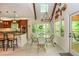 Bright dining area features large windows, modern lighting, and breakfast bar that connects to a gourmet kitchen at 210 Hunters Vw, Roswell, GA 30075