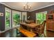 Inviting dining room with abundant natural light, stylish decor, and a rustic wood table with bench seating at 210 Hunters Vw, Roswell, GA 30075