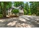 Charming Tudor-style home with well-manicured landscaping and a spacious driveway at 210 Hunters Vw, Roswell, GA 30075
